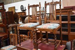 A set of two plus three golden oak dining chairs.