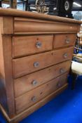 A late Victorian Scotch style chest of two over three drawers in stripped pine.