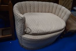 A 20th century loving chair for two with cream upholstery.