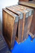 A stack of five vintage bakers bread trays.