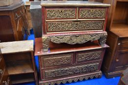 Two mid Victorian low chests of two over two drawers with heavily carved Chinoiserie design.
