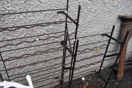 Two vintage wrought iron wine racks.