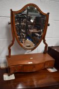 An 18th century shield shaped toilet mirror with a satin wood frame.