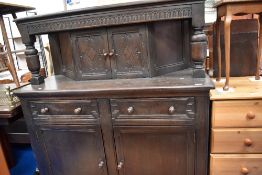An early 20th century tabernacle style side board in dark stained oak.