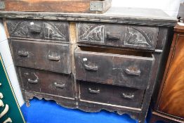 An antique chest of six large drawers with carved fronts