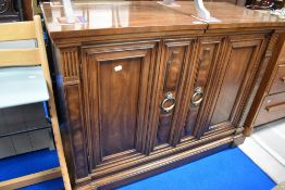 A modern breakfast or buffet bar having Mahogany case with brass handles.
