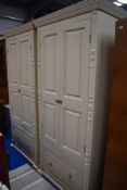 A pair of modern painted pine hall wardrobes with under drawer.