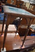 A Victorian plant stand table with tile top.