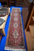 A Turkish style woven carpet runner with a similar cream rug.