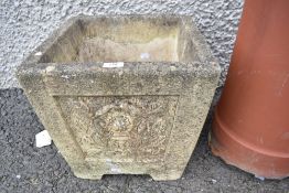A composite stone cast garden planter.
