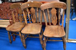 Three early 20th century Beech wood dining chairs with vase style backs.