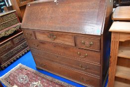 A large early Victorian oak framed bureau with three over three drawers.