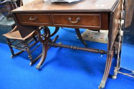 A reproduction side table having double frieze drawers, drop flaps and lyre ends
