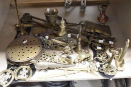 A collection of brass ornaments including Fly, Anchor, fire side set and chestnut roaster.