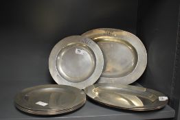 A group of nine 19th century pewter plates, each with engraved initials AAB and Carpenter touch