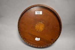An unusual small Edwardian inlaid mahogany circular tray, of small proportions with central sunburst