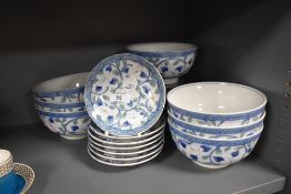A quantity of 20th century Chinese bowls and saucers, decorated with profuse scrolling foliage