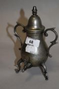 A miniature ornamental pewter samovar, of baluster form with domed finial topped cover over scrolled