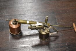 An antique 'The Four Oaks' copper and brass garden sprayer and brass blow torch
