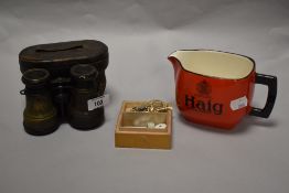 A pair of 19th century field glasses, a Haig water jug and a small enamelled Coniston Hunt