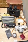A Ricoh 300 camera body and Ricoh lens, a pair of SUI binoculars with leather covered card case,
