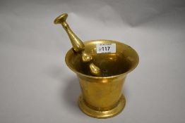 A 18th century apothecary or similar mortar and pestle, mortar of traditional fluted bell form