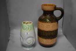 A large West German pottery vase, with single handle and bands of textured and impressed