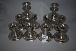 Five pairs of silver-plated squat candlesticks, each with bead moulded decoration 7.5cm