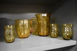 A vintage Thomas Webb English Bullseye style yellow glass vase with a water jug and three glasses.