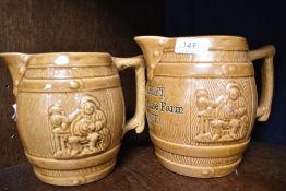 Two early 20th century barrel form milk jugs with impressed harvest scenes, one marked S Ashcroft,