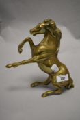 A vintage cast-brass study of a rearing/distressed horse