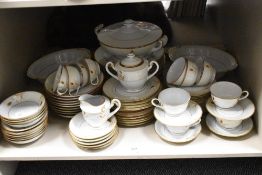 A partial dinner service having gilt accents to white ground,to be included are cups, saucers, turee