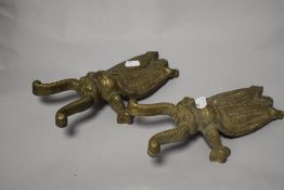 A pair of vintage cast-brass beetle-form boot jacks