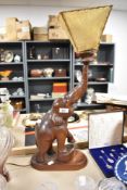 An early 20th century figural lamp of an Indian Elephant carved in hard wood.