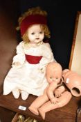 A vintage mid-century Pedigree doll with sleeping eyes, and material garments, sold along with a