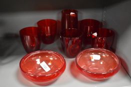 A selection of vintage Cranberry glass wares including two Whitefriars style dishes.