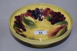 A Moorcroft Pottery 'Leaf and Berry' pattern footed bowl, of circular form, tube-lined with fruit