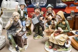 A group of five continental Capodimonte style porcelain figures, watch maker, busking tramp, young