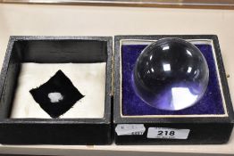 A cased crystal ball, within a plush-lined and fitted box.