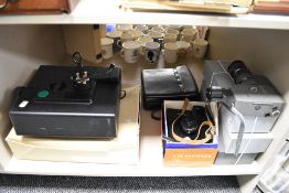 A collection of film and photographic equipment including a Super 8mm camera and a slide projector.