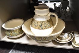 An early 20th century Doulton wash jug chamber pot and bowl set with cream ground and gilt