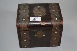 A Victorian brass bound simulated rosewood tea caddy, the brass mounts with mother-of-pearl