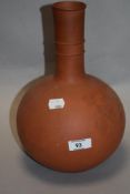 A nicely turned and proportioned terracotta vase, with slender knopped neck over the globular
