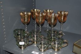 A group of six vintage Turkish tea glasses, tinted green with attached metal handles, sold along