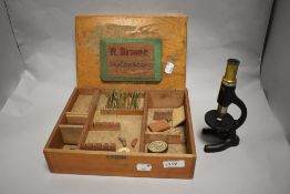 A 20th century Milbro x 250 scientific childrens microscope with case and some slides.