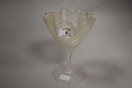 A 19th century hand-blown iridescent glass, of ruffled conical form with slender stem and circular