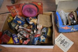 A box of parts and spares, most boxed, including spark plugs, head lamp, bulbs etc.