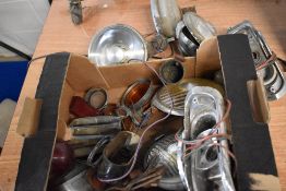 A collection of vintage vehicle lights and lenses, including head lamps etc.