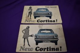 A Ford Cortina service book and an owner handbook, 1966 dated.