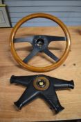 A vintage Momo steering wheel, with horn press.